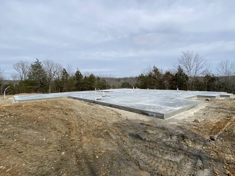 Large concrete slab poured and finished on a rural building site