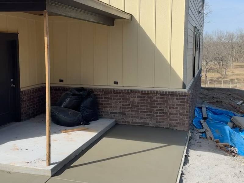 Concrete approach and walkway poured at the entry of a new home